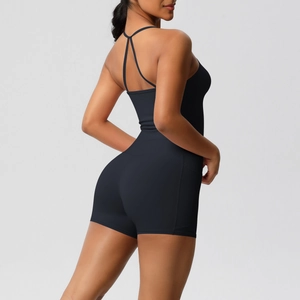 Close-up of black strapless jumpsuit with criss-cross back detail for yoga