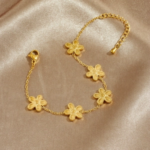 Elegant gold plated stainless steel bracelet with five petal flower charms on silk