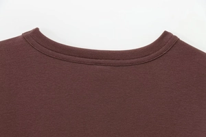 Detailed close-up of crew neckline and stitching on a dark brown modal t-shirt