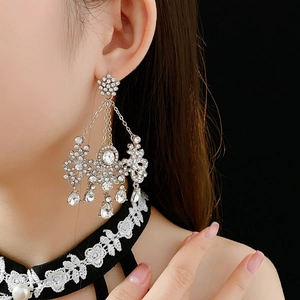 Close-up of sparkling chandelier earrings with silver rhinestones and water drop tassels