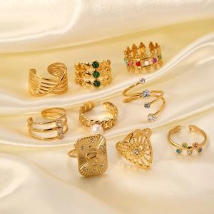 Vintage gold open ring set with zircon, pearls and drip oil on cream silk fabric