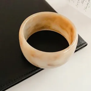 Vintage round resin bangle with amber marble texture in creamy caramel finish