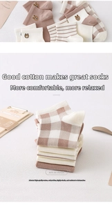 Detailed view of beige and brown cotton socks featuring cute bear embroidery and patterns