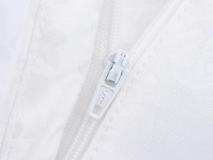 Close-up of white jacquard fabric texture and sturdy metal zipper on suit trousers