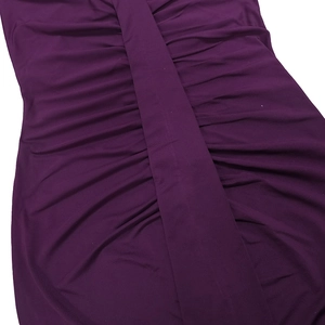 Detail of deep purple dress featuring intricate ruching and gathered elastic fabric texture