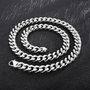 Macro detail of 14mm silver titanium steel Cuban link chain with secure spring clasp
