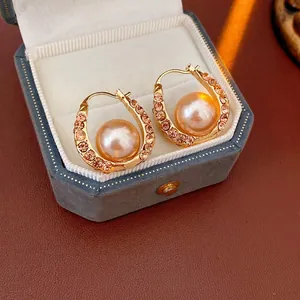 French vintage U-shape pearl earrings with pink rhinestones on a gold frame in a gift box