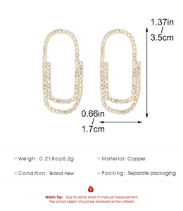 Detailed view of gold copper paperclip earrings with micro-pave clear cubic zirconia stones