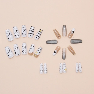 Detail of assorted cat-eye press-on nails featuring heart patterns and star accents