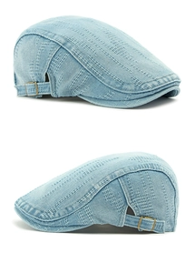 Detail of light blue denim flat cap featuring jacquard texture and metal side adjustment buckle
