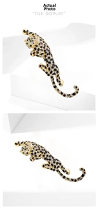 Macro detail of leopard brooch with white crystals, black stones and green gem eyes