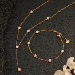 Elegant gold stainless steel necklace and bracelet set with round and pear-shaped zircon