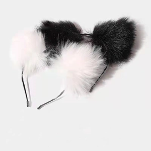 Close-up of plush black and white cat ear headband with soft artificial fur material