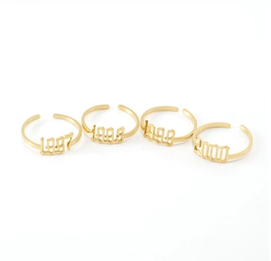 Set of four gold-plated stainless steel birth year rings featuring 1997 to 2000 engravings