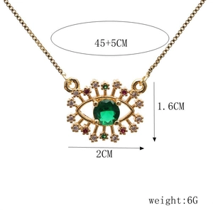 Detail view of gold dragonfly evil eye necklace with green stone and size dimensions