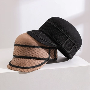 Detail view of wool newsboy hats with black mesh veil in tan and black colors