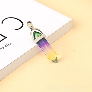 Macro detail of hexagonal crystal pendant with purple and yellow gradient and silver clasp