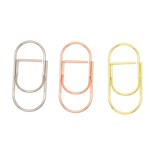 Metallic paper clips set in gold, silver, and rose gold finishes on white background