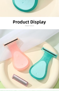 Close-up of pastel pink and green women's razors with anti-slip handles and dual blades