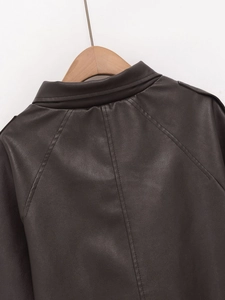Detailed view of the faux leather jacket collar and shoulder texture on a wooden hanger