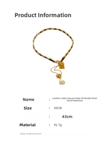 Detail view of OT clasp pearl necklace with faux leather chain and square letter pendant