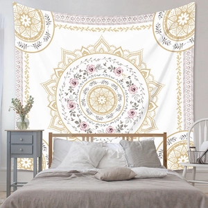 Detail of bohemian mandala tapestry with pink roses hanging on a bedroom wall