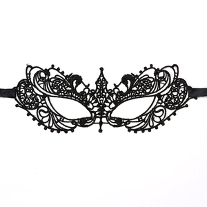 Detailed view of intricate black lace masquerade mask with floral patterns and silk ribbons
