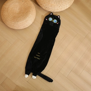Long black cat plush pillow with soft embroidery details on wooden floor background