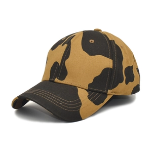 Detailed close-up of cow print baseball cap featuring brown and black bionic patterns
