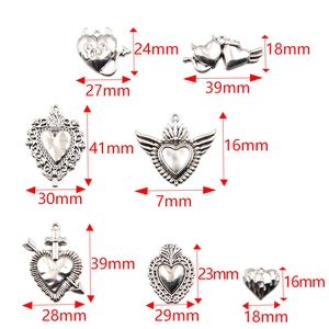 Seven silver Halloween heart charms in various designs with precise size measurements