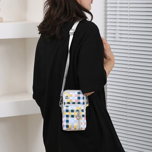 Colorful checkered oxford cross-body cell phone bag with heart zipper on black T-shirt