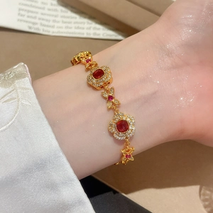 Detailed close-up of 24K gold-plated flower bracelet with square ruby and white zircon