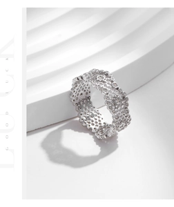 Macro detail of S925 silver hollow honeycomb ring with sparkling pavé cubic zirconia