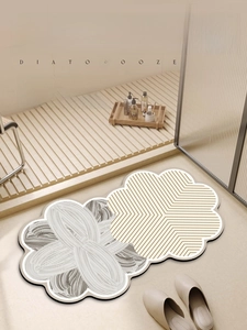 Detail view of flower-shaped diatom mud bath mat with dual textures on wooden floor