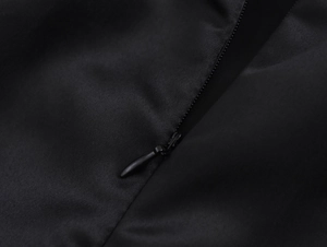 Close-up of high-quality invisible back zipper on the elegant black flared dress