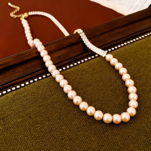 Detailed macro view of vintage pearl necklace with rectangular zircon and gold clasp