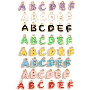Macro shot of colorful enamel alphabet A-F pendants for DIY jewelry making
