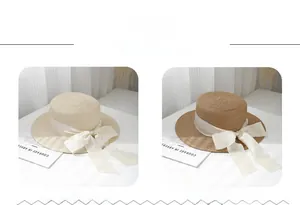 Detailed weave texture of flat top straw hats in off-white and khaki with bow ribbons