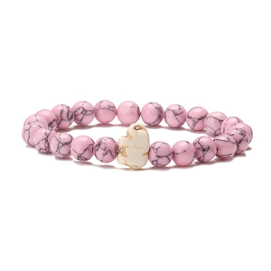 Detail of pink marble beads stretch bracelet featuring a white elephant charm centerpiece