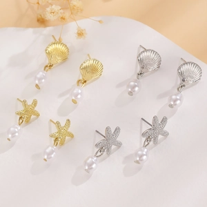 Starfish and seashell stud earrings with pearls in gold and silver finish on white background