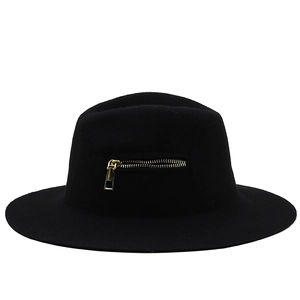 Detail of black wool fedora featuring a decorative gold metal zipper on the brim