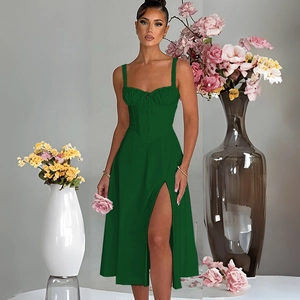 Detail of green square neck dress showing ruched bust and elegant side slit hemline