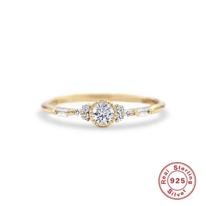 Detail view of gold-plated 925 sterling silver ring with cluster-set round and baguette stones
