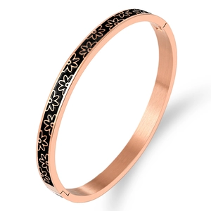 Rose gold daisy enamel bangle featuring a brushed metal finish and floral pattern