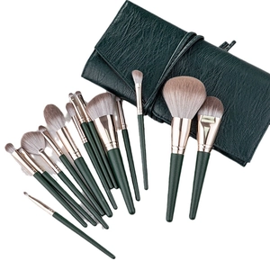 14-piece dark green makeup brush set with rose gold ferrules and portable roll case