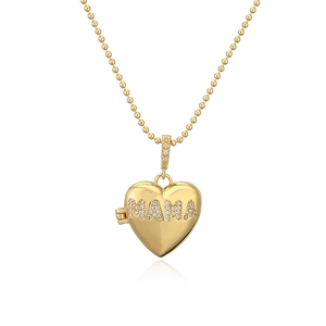 Golden heart locket necklace with sparkling MAMA crystal lettering on white background
