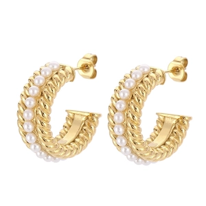 Elegant French vintage C-shape gold earrings with pearl trim on white background