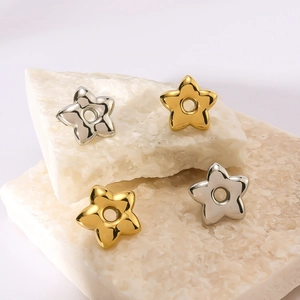 Chunky hollow star stainless steel earrings in gold and silver finish on white stones
