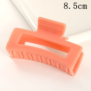Close-up of a 8.5cm coral pink rectangular claw clip with a glossy hollowed design