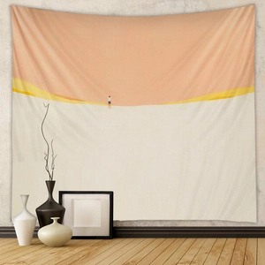 Detail view of a minimalist desert tapestry with a warm orange sun on a textured wall